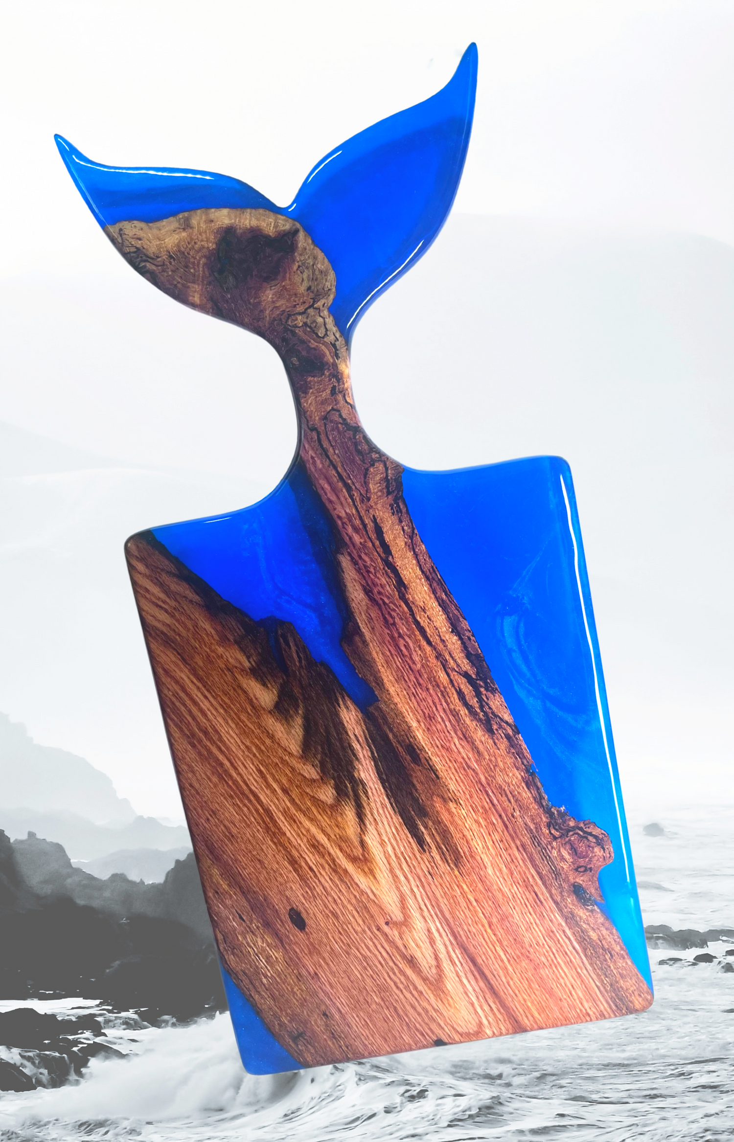 Stunning whale tail serving tray using live edge wood and a royal blue epoxy resin. It is sure to impress!!