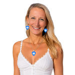 Woman wearing blue heart-shaped earrings and a necklace on a white background