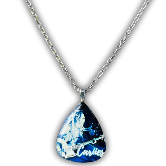 Guitar pick necklace featuring a blue-toned photo of Cariies playing bass with a silver chain and pearl grey back.
