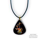 Close-up of handcrafted GRF Stella’s Flight necklace showing the vibrant Golden Road Festival butterfly-and-guitar artwork under a glossy epoxy finish.