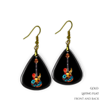 Close-up of Stella’s Jam earrings showing glossy black guitar pick design with vivid guitar art.