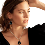 GRF – Stella’s Jam necklace on model featuring colorful guitar artwork with gold hooks and chain.