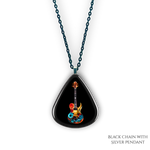 Close-up of Stella’s Jam necklace showing glossy black guitar pick design with vivid guitar art.