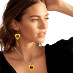 Golden Road Flight necklace featuring yellow glossy guitar pick design with the golden road festival bird and Steal Your Face logo.